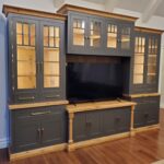 A huge wooden cabinet with a television