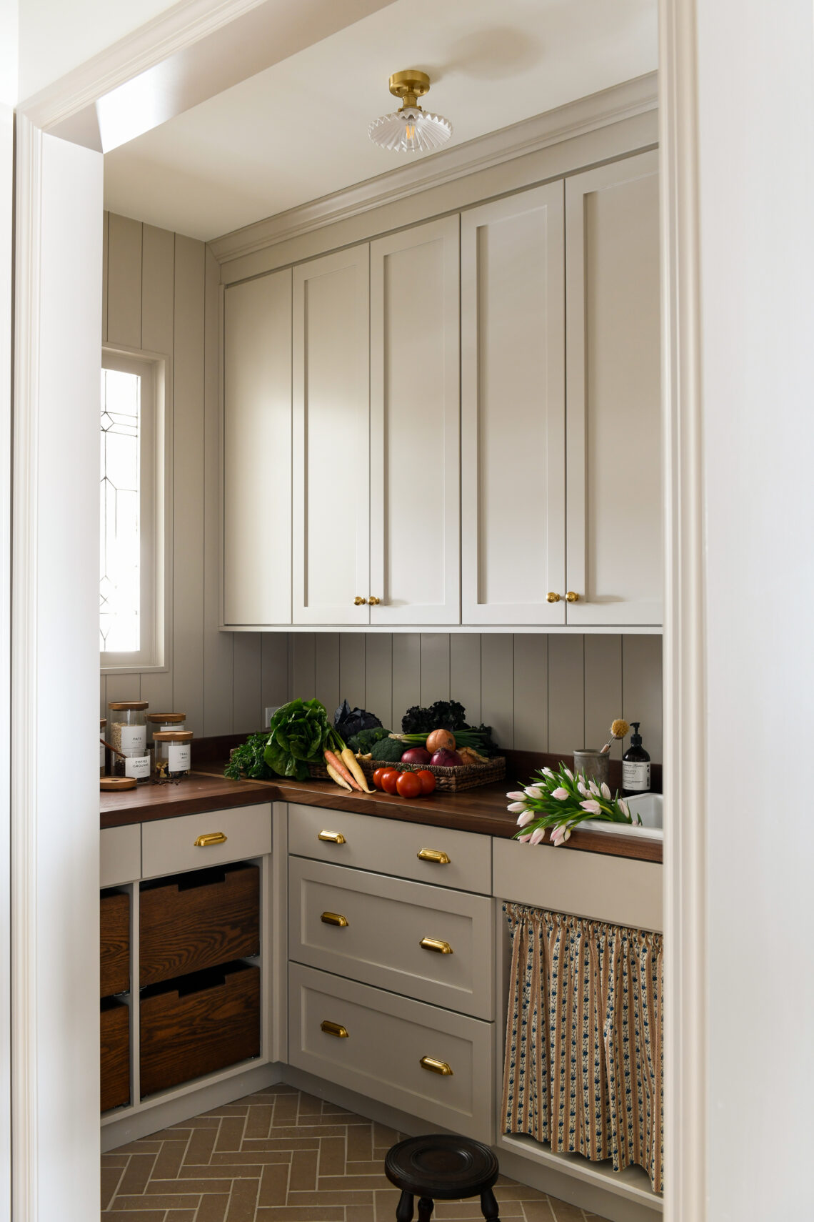 Pantry with cabinets, wooden countertop, fresh produce